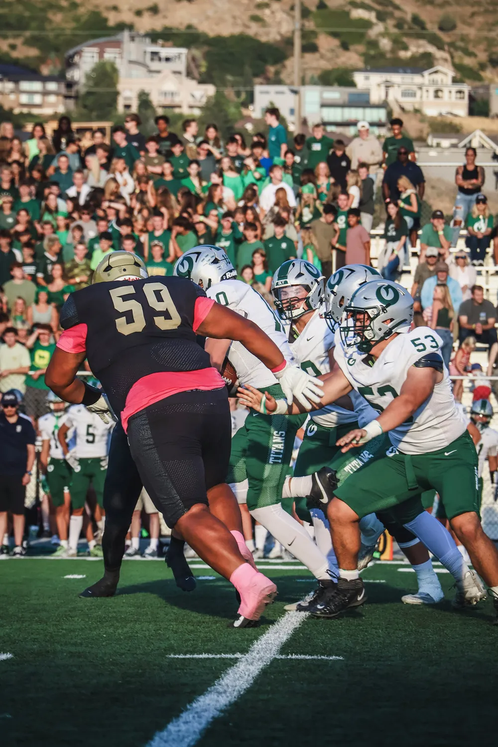 Ammon Sanchez #59 firing off the line of scrimmage against Olympus High School